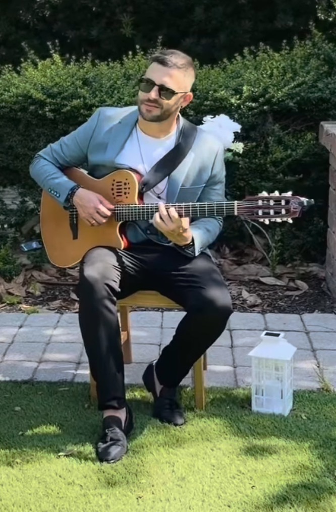 Ofrey seated live performance